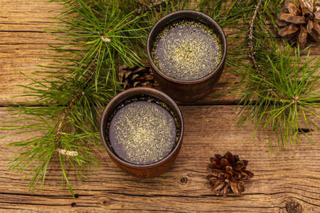 Pine needle tea, sollip-cha, traditional Korean beverage. Alternative medicine, healthy life style. Vintage wooden boards backgroundの写真素材