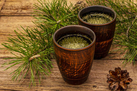 Pine needle tea, sollip-cha, traditional Korean beverage. Alternative medicine, healthy life style. Vintage wooden boards backgroundの写真素材
