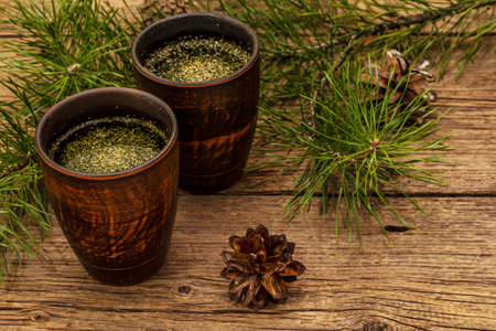 Pine needle tea, sollip-cha, traditional Korean beverage. Alternative medicine, healthy life style. Vintage wooden boards backgroundの写真素材