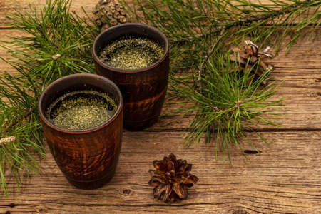 Pine needle tea, sollip-cha, traditional Korean beverage. Alternative medicine, healthy life style. Vintage wooden boards backgroundの写真素材
