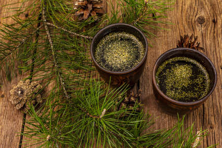 Pine needle tea, sollip-cha, traditional Korean beverage. Alternative medicine, healthy life style. Vintage wooden boards backgroundの写真素材
