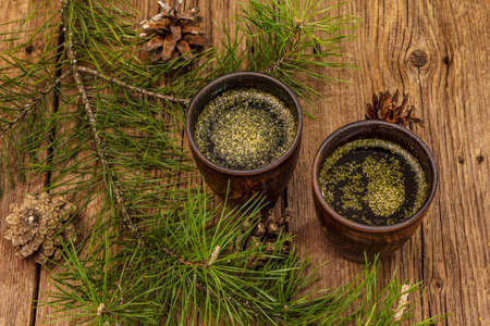 Pine needle tea, sollip-cha, traditional Korean beverage. Alternative medicine, healthy life style. Vintage wooden boards backgroundの写真素材
