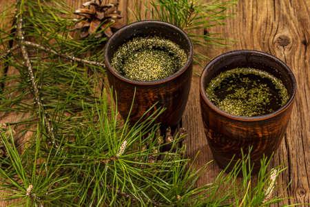 Pine needle tea, sollip-cha, traditional Korean beverage. Alternative medicine, healthy life style. Vintage wooden boards backgroundの写真素材