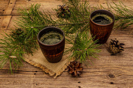 Pine needle tea, sollip-cha, traditional Korean beverage. Alternative medicine, healthy life style. Vintage wooden boards backgroundの写真素材