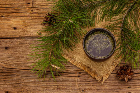 Pine needle tea, sollip-cha, traditional Korean beverage. Alternative medicine, healthy life style. Vintage wooden boards backgroundの写真素材