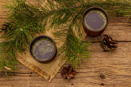 Pine needle tea, sollip-cha, traditional Korean beverage. Alternative medicine, healthy life style. Vintage wooden boards backgroundの写真素材