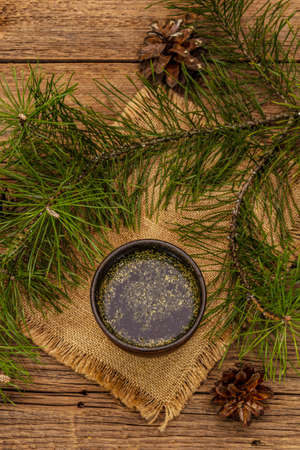Pine needle tea, sollip-cha, traditional Korean beverage. Alternative medicine, healthy life style. Vintage wooden boards backgroundの写真素材