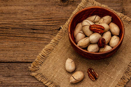 Ripe pecan on vintage wooden background. Traditional ingredient for pecan pie in USAの写真素材