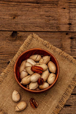 Ripe pecan on vintage wooden background. Traditional ingredient for pecan pie in USAの写真素材