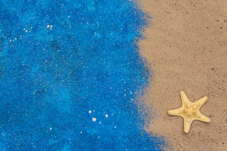 Navy blue nautical summer background wish sand and sea star, top viewの写真素材