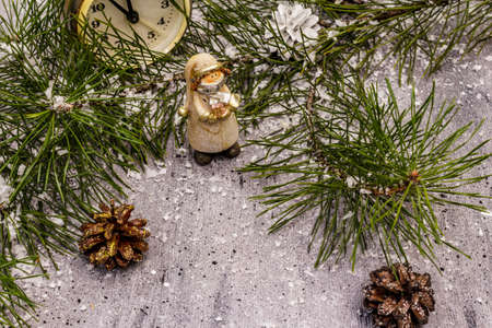 Few minutes to midnight. New Year concept. Alarm clock, pine branch, Christmas decorations. Grey stone concrete backgroundの写真素材