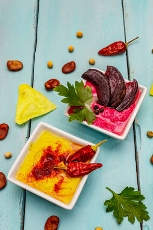 Hummus, healthy vegan (vegetarian) food. Assorted three types: classic, mint and beetroot. Edamame...