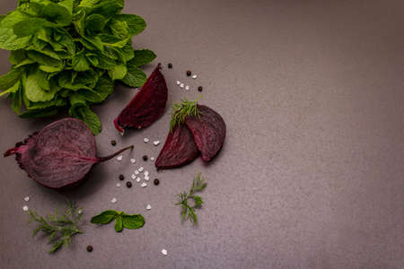 Culinary background. Cooking food concept. Beetroot, fresh mint, dill, sea salt, peppercorn. Trendy black stone concrete backdrop, copy spaceの写真素材
