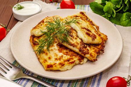 Hot appetizer - pita bread with cheese and herbs. Vegetarian healthy food. Wood table background, close upの写真素材