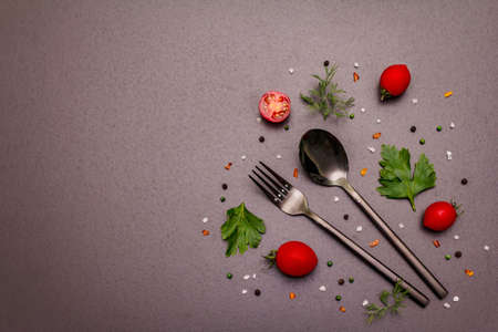Culinary background. Cooking food concept. Cutlery, fresh vegetables, spices, herbs. Trendy black stone concrete backdrop, copy space, top viewの写真素材