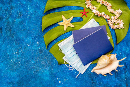 Travel and vacation coronavirus concept. Summer 2020 background with medical mask, passports,...