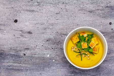 Yellow zucchini cream soup. Healthy vegan (vegetarian) food, crispy toast, sunflower seeds, fresh...