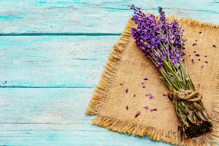 A fresh bouquet of fragrant lavender. Romantic gift, turquoise wooden boards background, copy spaceの写真素材