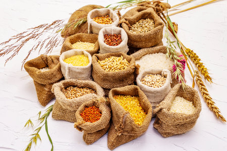 Assorted variety of cereals. An indispensable ingredient for a healthy diet. Handmade bags, white...