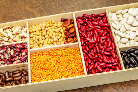 Set of various dry legumes in wooden box, indispensable protein for a healthy lifestyle. Assorted...