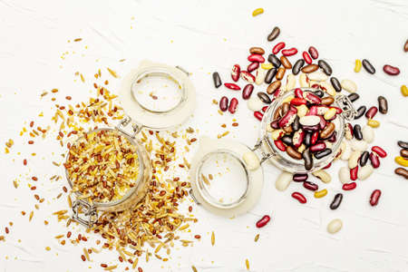 Mix of variety of cereals and beans in glass jars. Set of indispensable sources of protein for a...