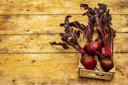 Fresh homegrown beetroot with leaves in crate. Healthy plant based food, local produce harvest,...