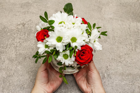 Valentine's Day or Wedding or Happy Birthday concept. Female hands are holding a bouquet of flowers....