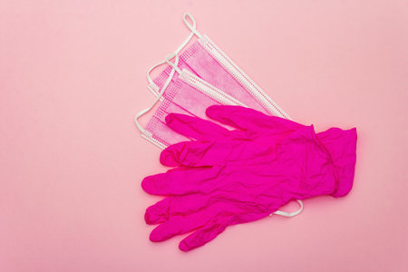 Fashion masks and glamor gloves isolated on pink background. Medical products for personal hygiene...