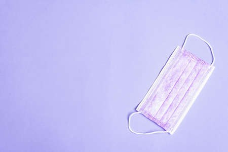 Fashion lilac masks isolated on glamor purple background. Medical products for personal hygiene and the prevention of viral diseases. Coronavirus, COVID-19 pandemic worldwide conceptの写真素材