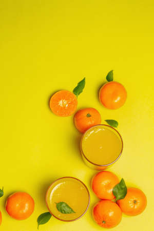 Sweet fruit jelly from fresh oranges and tangerines. Sunny healthy dessert on bright yellow backgroundの写真素材