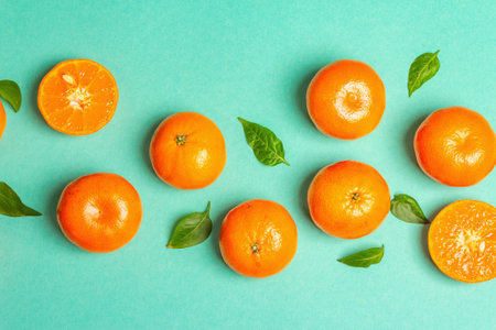 Ripe juicy tangerines and fresh leaves. Sunny summer turquoise backgroundの写真素材