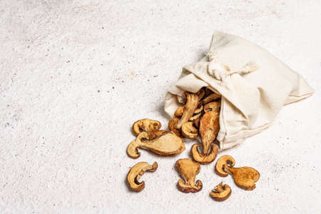 Forest dried edible mushrooms in a linen sack. Dehydrated slices, exquisite ingredient for cooking...