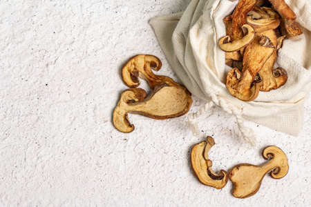 Forest dried edible mushrooms in a linen sack. Dehydrated slices, exquisite ingredient for cooking...