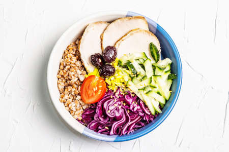 Buddha Bowl. Buckwheat, baked lean pork, red cabbage, cucumber, tomato, olives, flax seeds. Healthy...