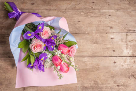 A beautiful bouquet of wedding flowers on old wooden boards. The concept for a holiday gift for Birthday, March 8 or Valentine's Day. Greeting card, a place for text, top viewの写真素材