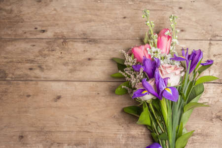 A beautiful bouquet of wedding flowers on old wooden boards. The concept for a holiday gift for Birthday, March 8 or Valentine's Day. Greeting card, a place for text, top viewの写真素材