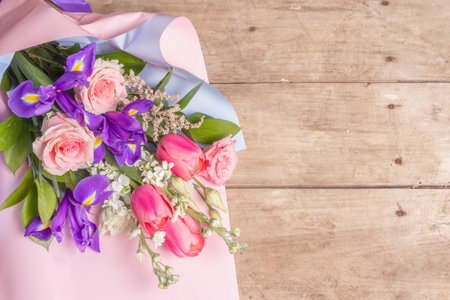 A beautiful bouquet of wedding flowers on old wooden boards. The concept for a holiday gift for Birthday, March 8 or Valentine's Day. Greeting card, a place for text, top viewの写真素材