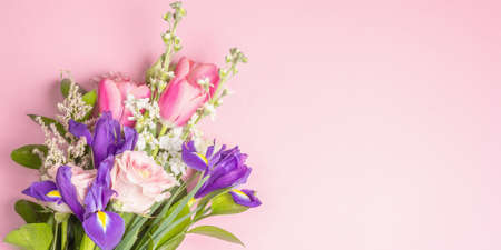 A beautiful bouquet of fresh flowers on a pink pastel background. The festive concept for Weddings,...