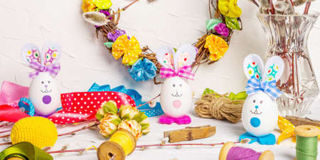 Festive Easter handmade concept. Traditional symbols with eggs, funny bunnies, accessories and...
