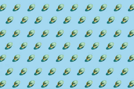 Omega-3 tablets pattern on a blue matte background. Healthy life concept, prevention of various diseases. Trendy hard light, dark shadow, flat lay, mockup, templateの写真素材