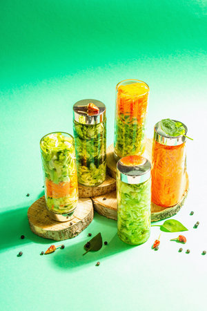 Healthy homemade cabbage salad in a glass jar. Set of various vitamin vegetables, spices, cutlery....