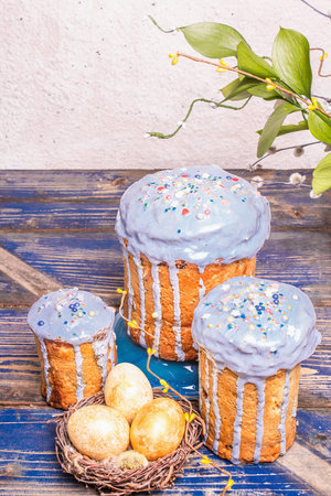 Easter cake with blue icing, topping, edible beads. Natural healthy ingredients, golden eggs in a...