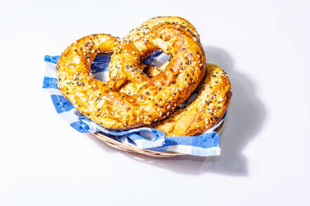 Oktoberfest concept - pretzels on a traditional napkin isolated on white background. A trendy hard light, dark shadow, mockupの写真素材