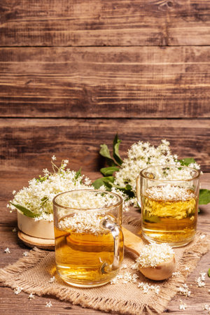 Elderberry flower tea. Refreshing summer drink, healthy lifestyle concept. Sackcloth napkin, vintage wooden table, copy spaceの写真素材