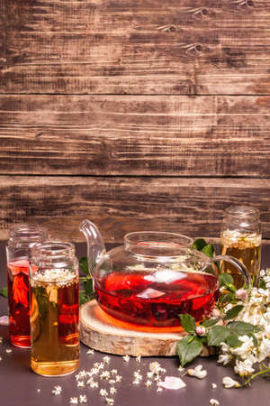 Assortment flowers tea. Fresh elderberry, rose hip, and acacia. Healthy food concept. Black stone concrete background, place for textの写真素材