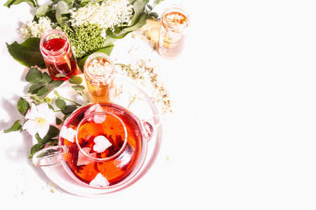 Assortment flowers tea. Fresh elderberry, rose hip, and acacia. Healthy food concept. White plaster background, top viewの写真素材