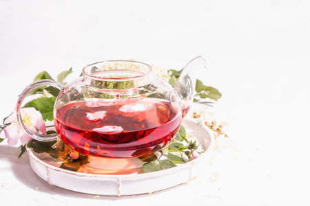 Assortment flowers tea. Fresh elderberry, rose hip, and acacia. Healthy food concept. White plaster background, copy spaceの写真素材