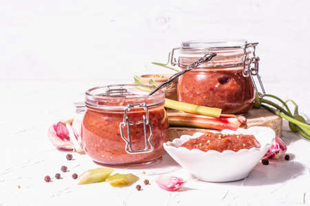 Chutney from rhubarb. Set of ingredients and spices for cooking. White putty background, close upの写真素材