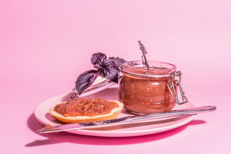 Chutney from rhubarb. Delicious food, traditional seasonal sauce. Pastel pink background, modern...
