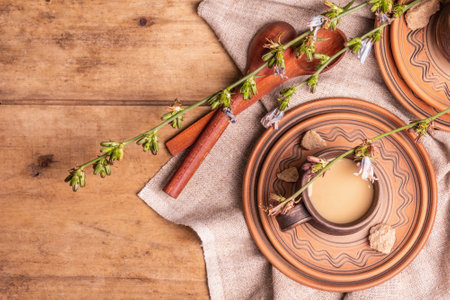 Hot natural chicory caffeine free drink in ceramic cups on a wooden table. Healthy alternative replacement for coffee, caffeine. Blue chicory flowers, fresh roots, top viewの写真素材
